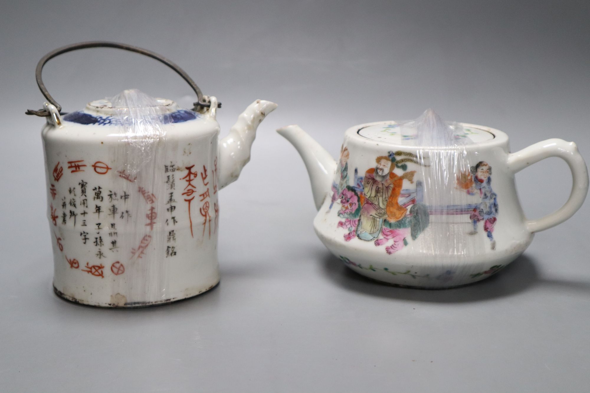 Two Chinese famille rose teapots and covers, and a calligraphic teapot, tallest 10cm